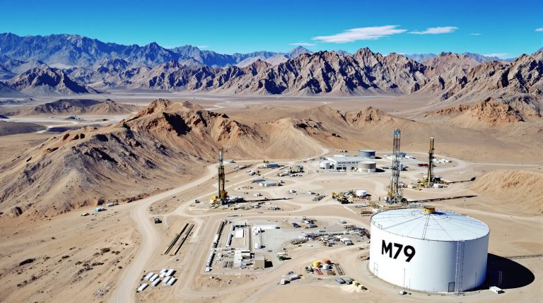 Mammoth Minerals Ltd-M79-Desert facility with storage tank, mountains.