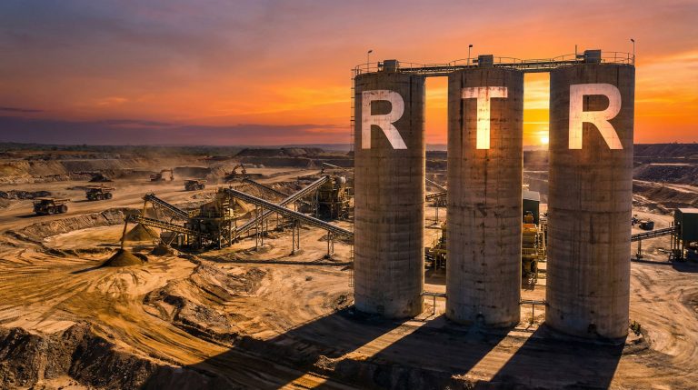 Rumble Resources Ltd-RTR-Mining operation at sunset with silos.