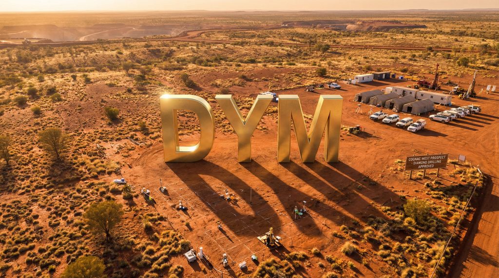 Dynamic Metals Ltd-DYM-DYM sign in desert landscape setting.