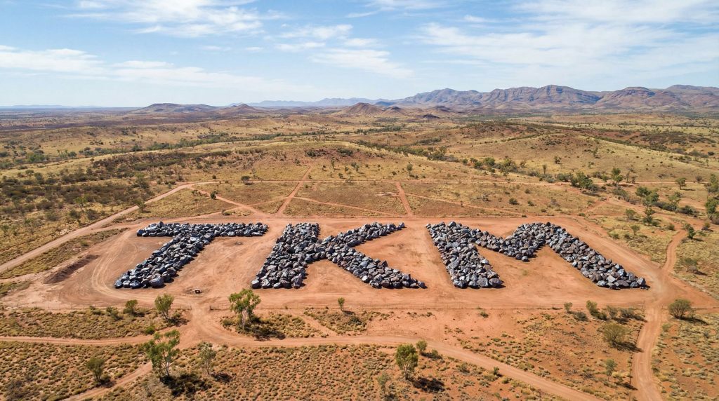 Trek Metals Ltd Chess Depositary Interests 1:1-TKM-TKM formation with rocks in desert.