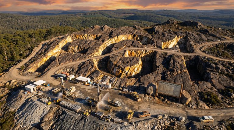 FLYNN Gold Ltd-FG1-Open-pit mine at sunset, aerial view.