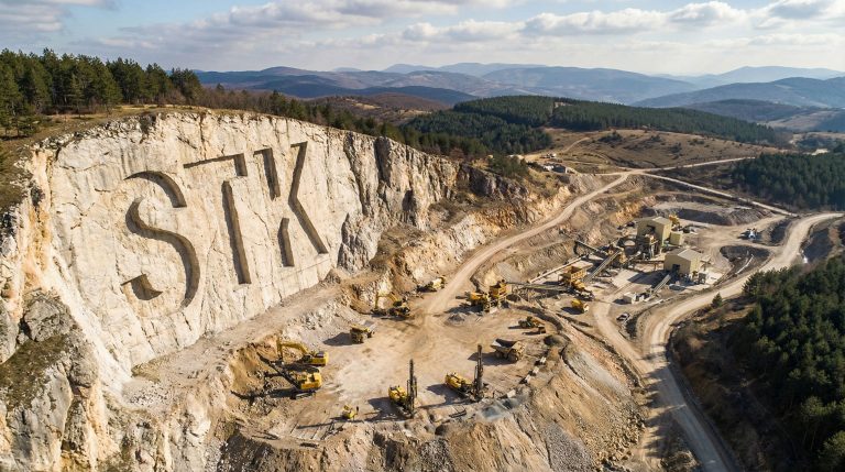 Strickland Metals Ltd-STK-STK carved in rocky hillside landscape.