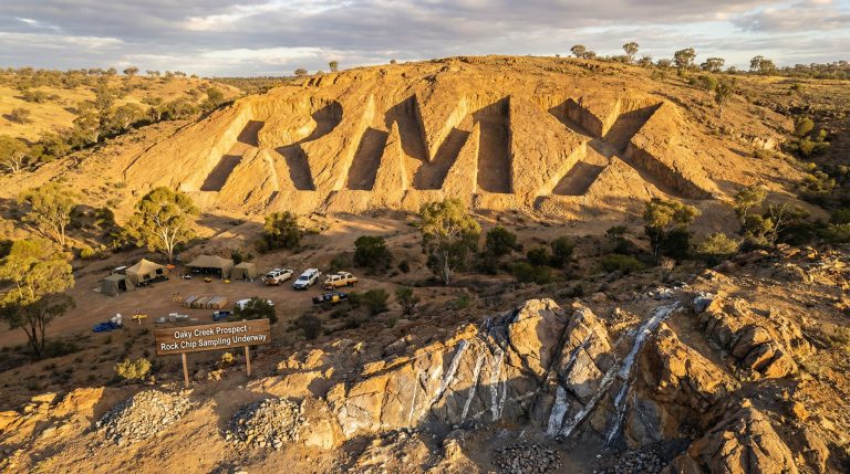 Red Mountain Mining Ltd-RMX-RMX letters carved into rocky hillside.