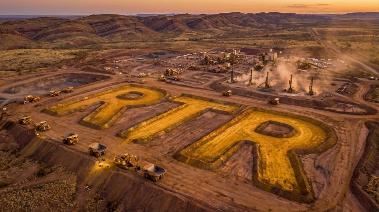 Rumble Resources Ltd-RTR-RTR letters at mining site, sunset.