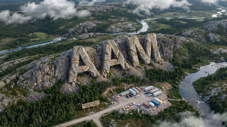 Aumega Metals Ltd-AAM-AAN rock formation overlooking forest landscape.