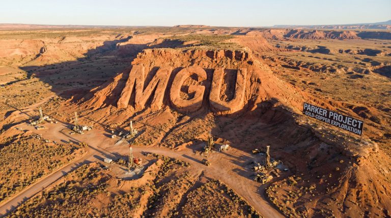 Magnum Mining and Exploration Ltd-MGU-Parker Project desert landscape with drills.