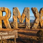 Red Mountain Mining Ltd-RMX-primary keyword giant stone letters landscape