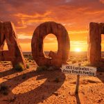 Ausquest Ltd-AQD-AQD desert rock letters at sunset