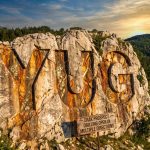 Yugo Metals Ltd-YUG-YUG carved into rocky mountainside at sunset